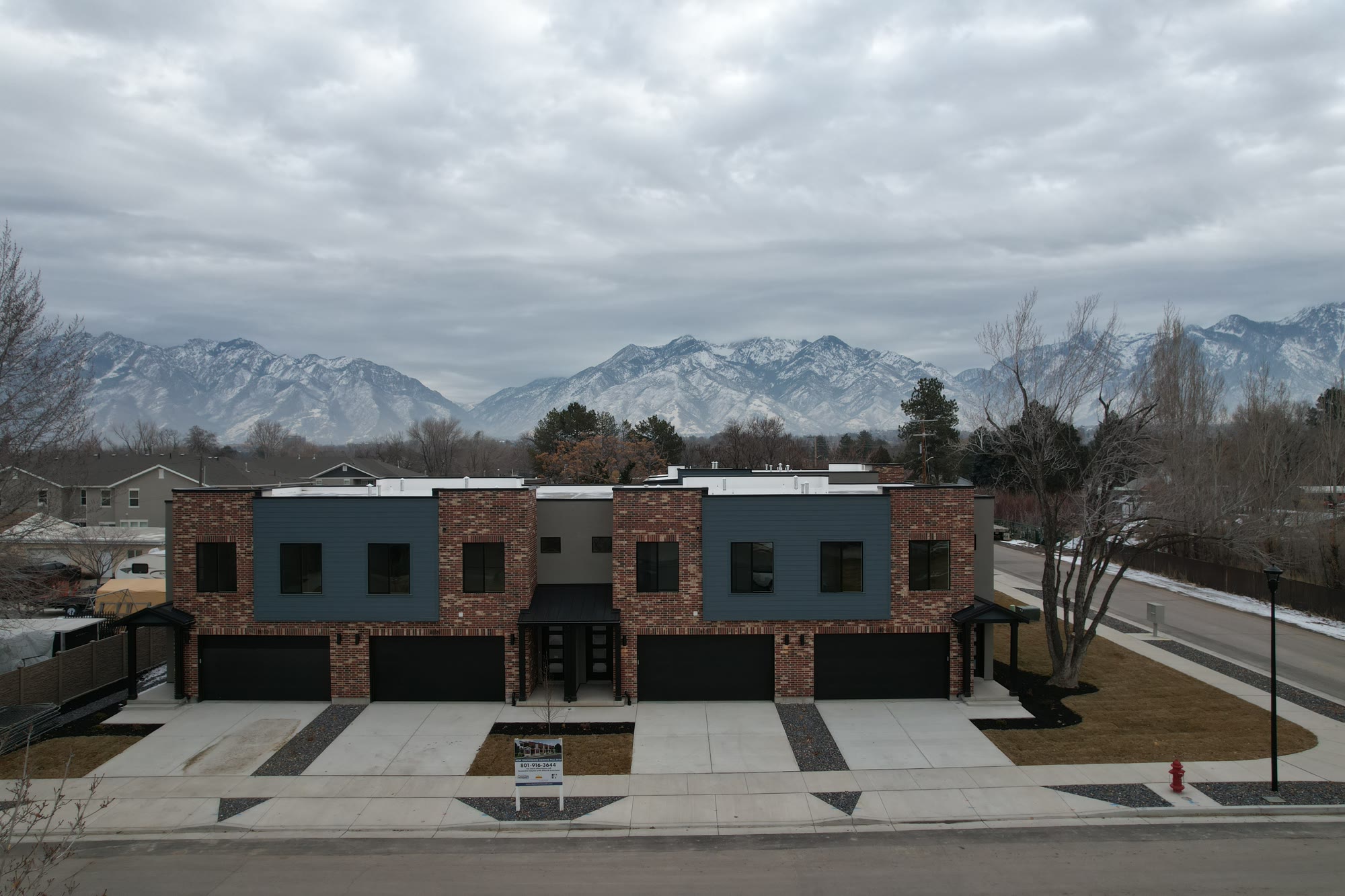 The finished brick and blue-panel exterior